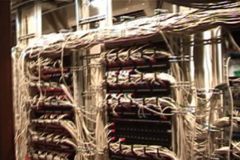 The back of a server rack displaying tidy bundles of network cables. CC BY-SA 3.0 <http://creativecommons.org/licenses/by-sa/3.0/>, via Wikimedia Commons